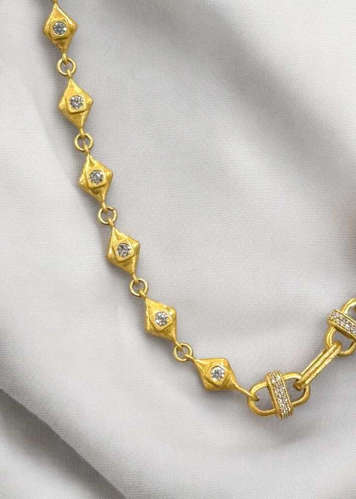 Gold chain necklace on a white background