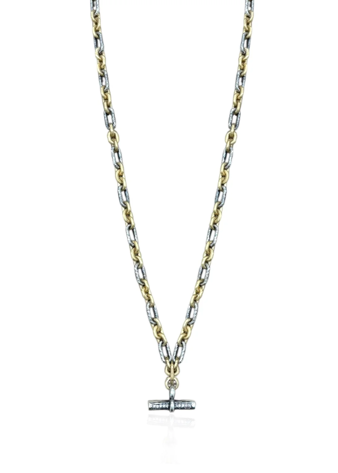 Mixed metal chain necklace with a CZ studded toggle on a white background