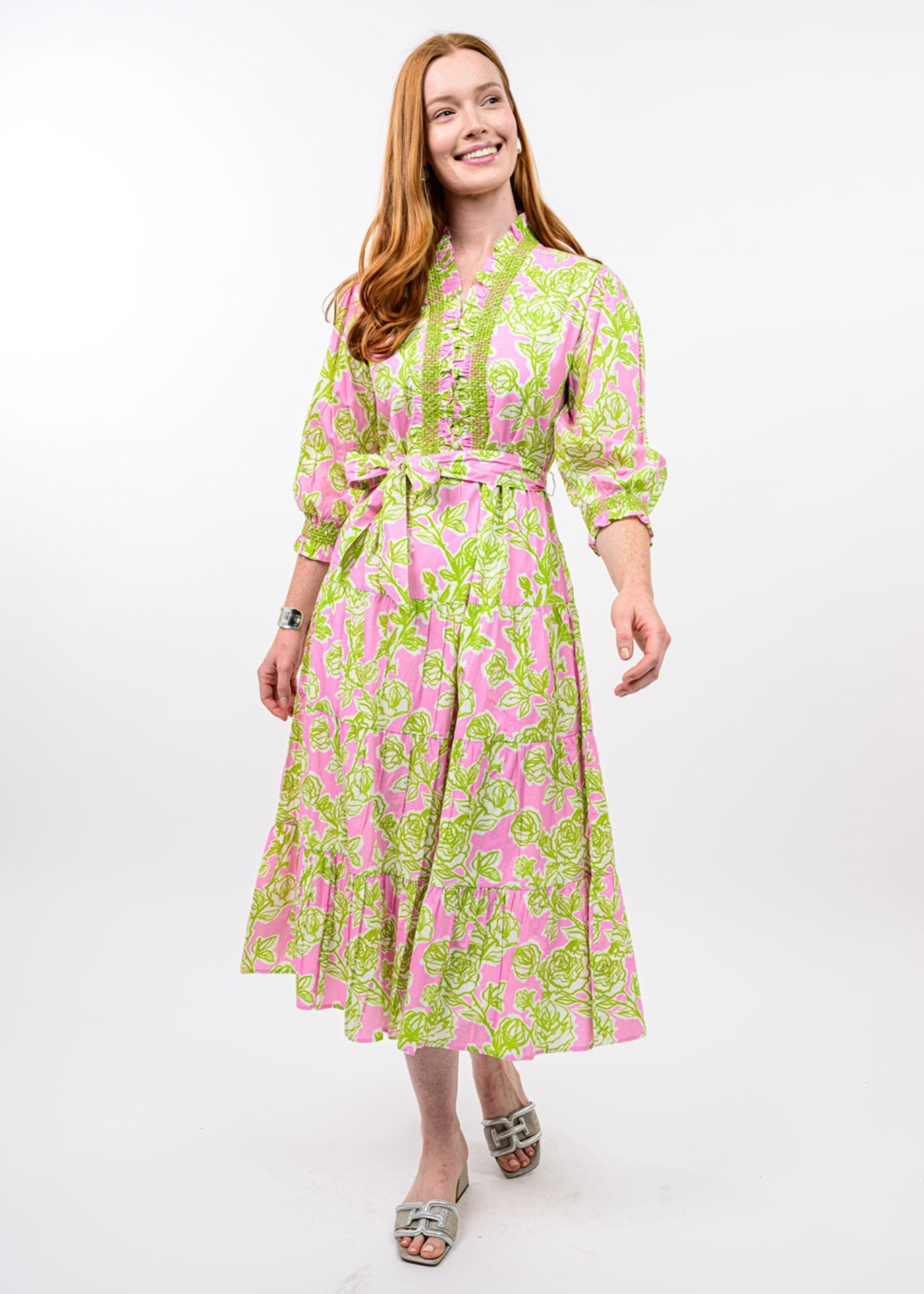 Woman wearing a pink and green floral midi dress