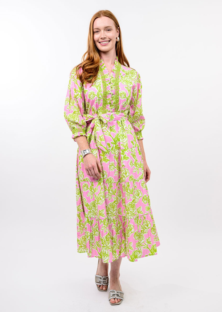 Woman wearing a pink and green floral midi dress