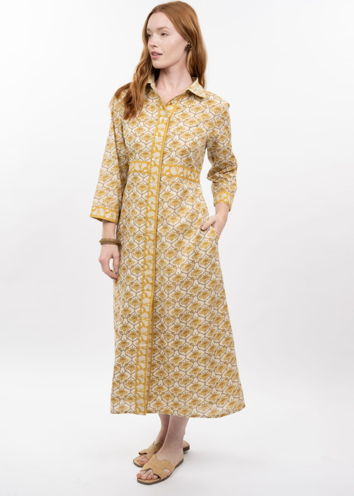 Woman wearing a gold floral print midi dress