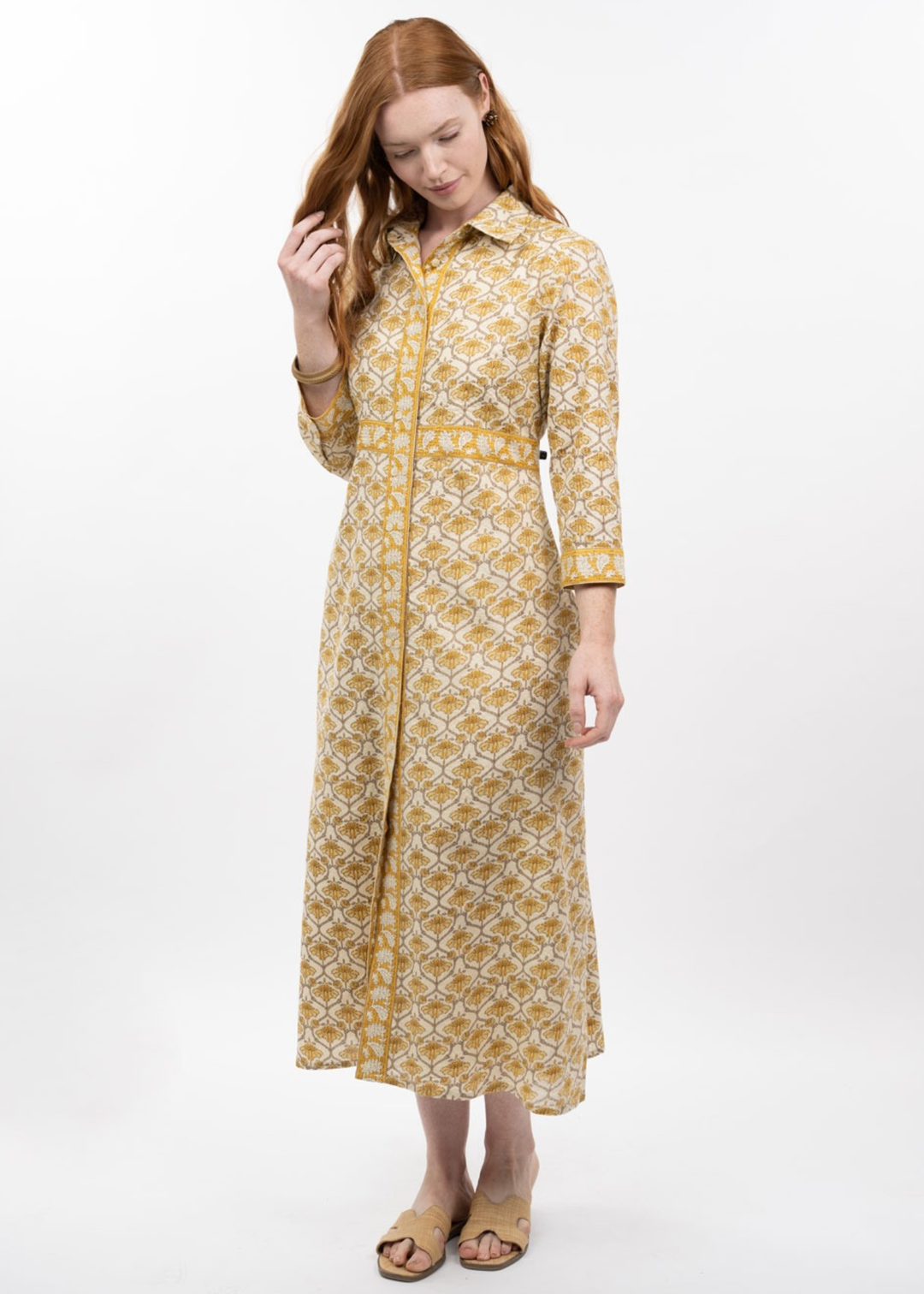 Woman wearing a gold floral print midi dress