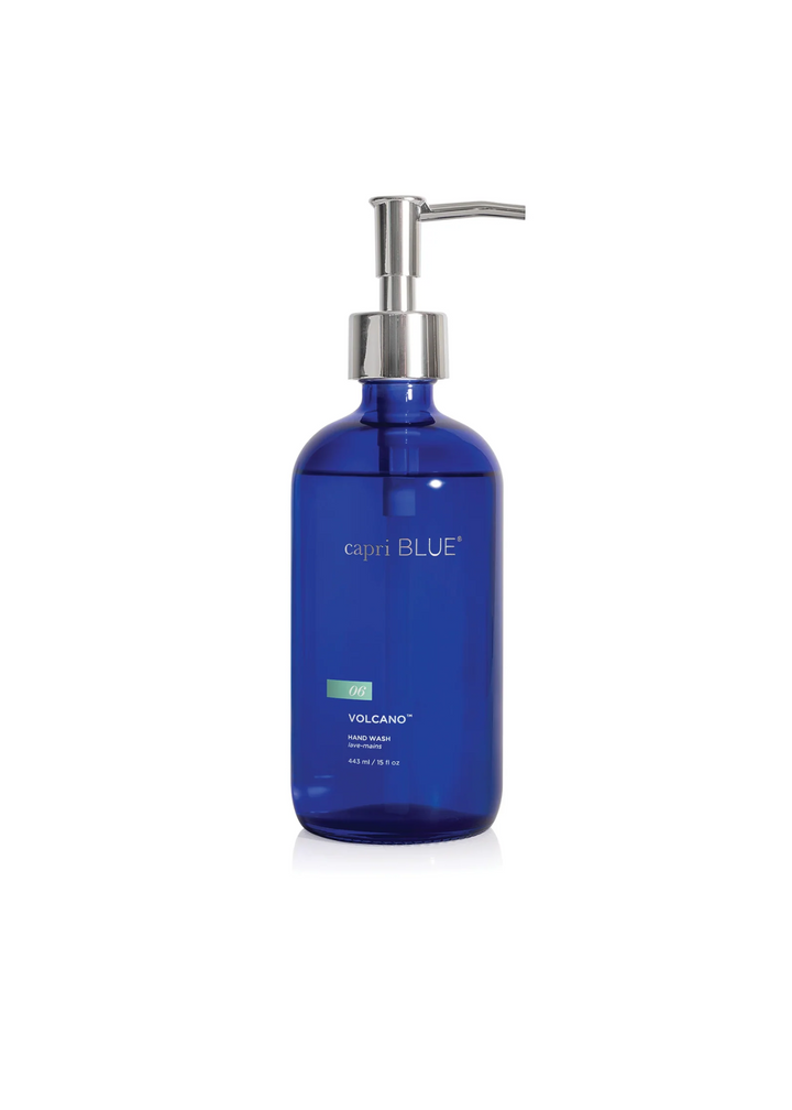 Cobalt blue soap bottle with a silver pump on a white background