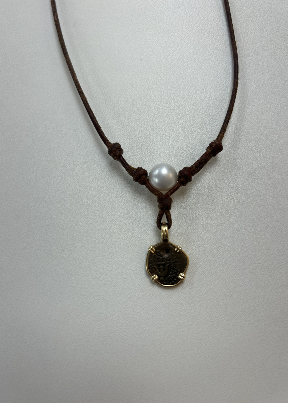 Brown leather necklace with a pearl and vintage coin