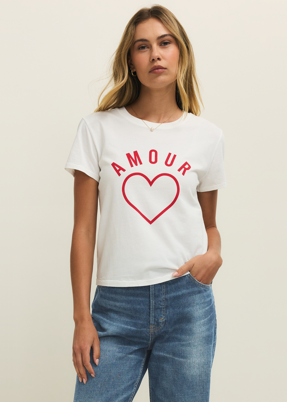 Woman wearing a white t-shirt with a red heart and "AMOUR" lettering