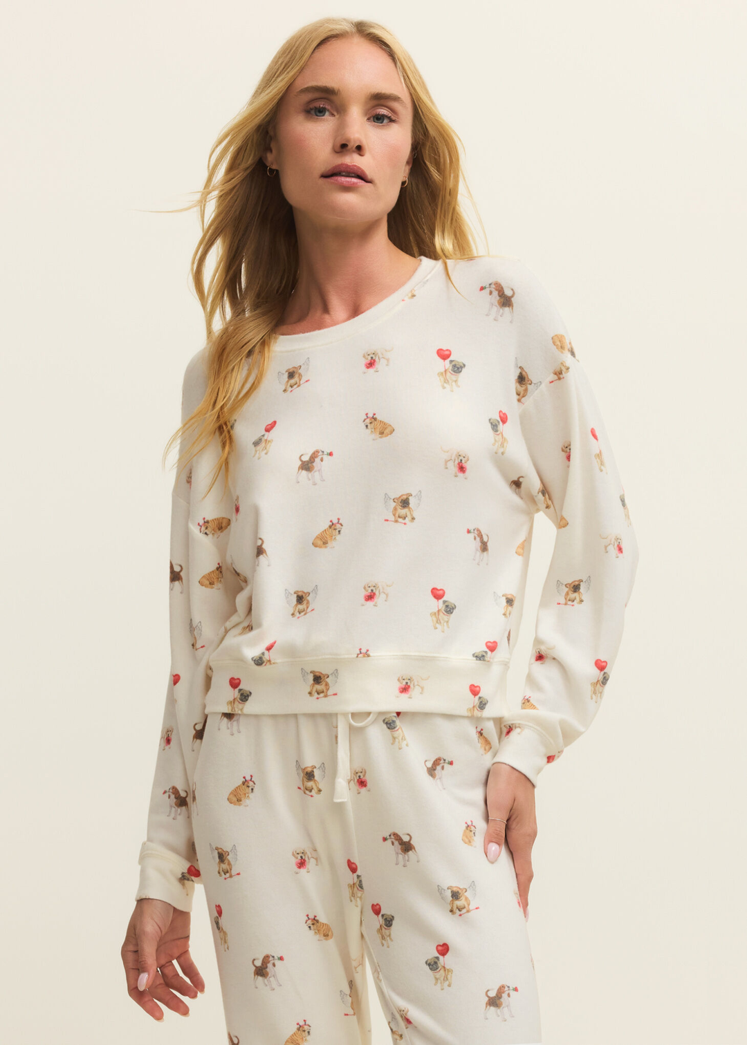 Woman wearing white pajamas with a graphic dog pattern