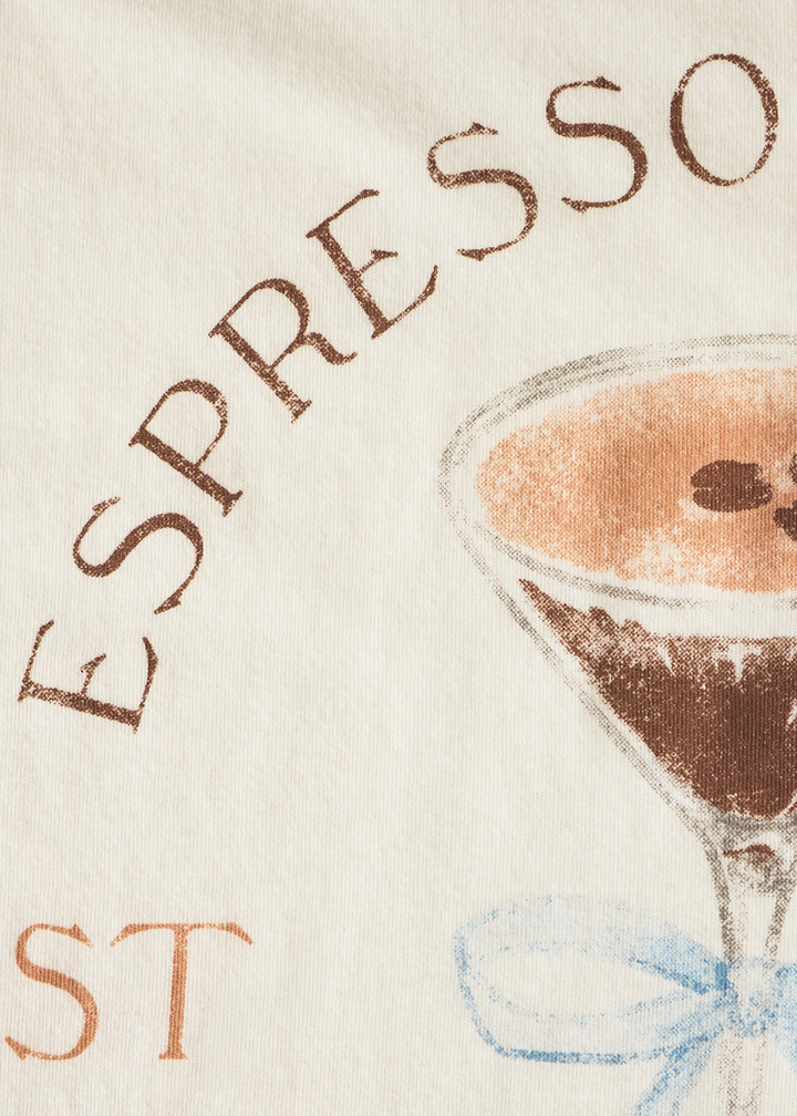 Close up of a shirt with an espresso martini graphic