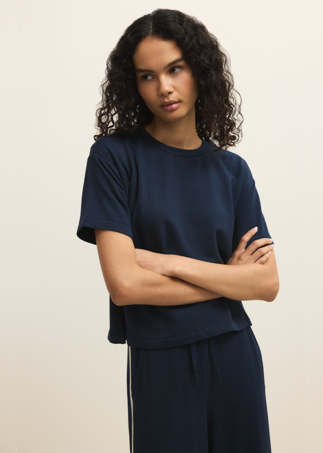 Woman wearing a navy short sleeve tee with navy pants