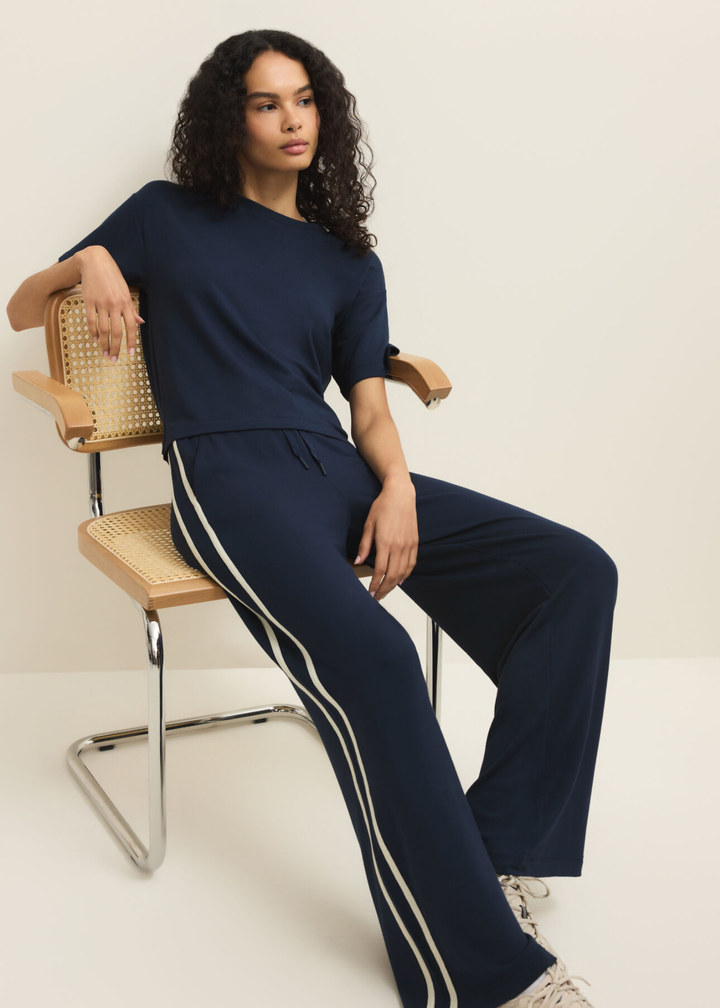 Woman wearing a navy short sleeve tee with navy pants