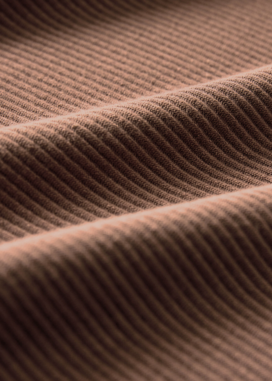 Close up of the fabric of a brown ribbed tank top