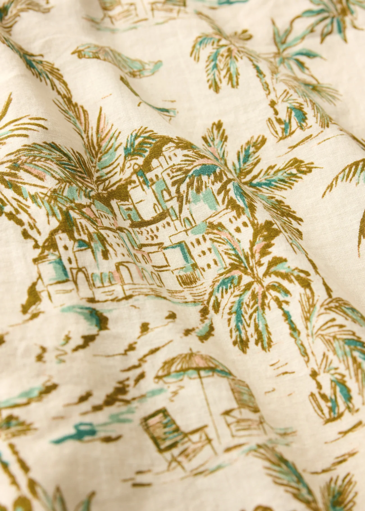 Close up of a cream fabric with a tropical print