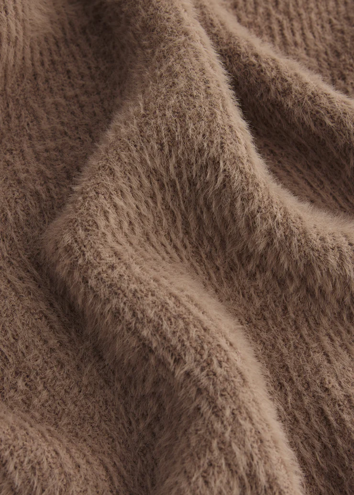 Close up of a fuzzy brown cardigan fabric
