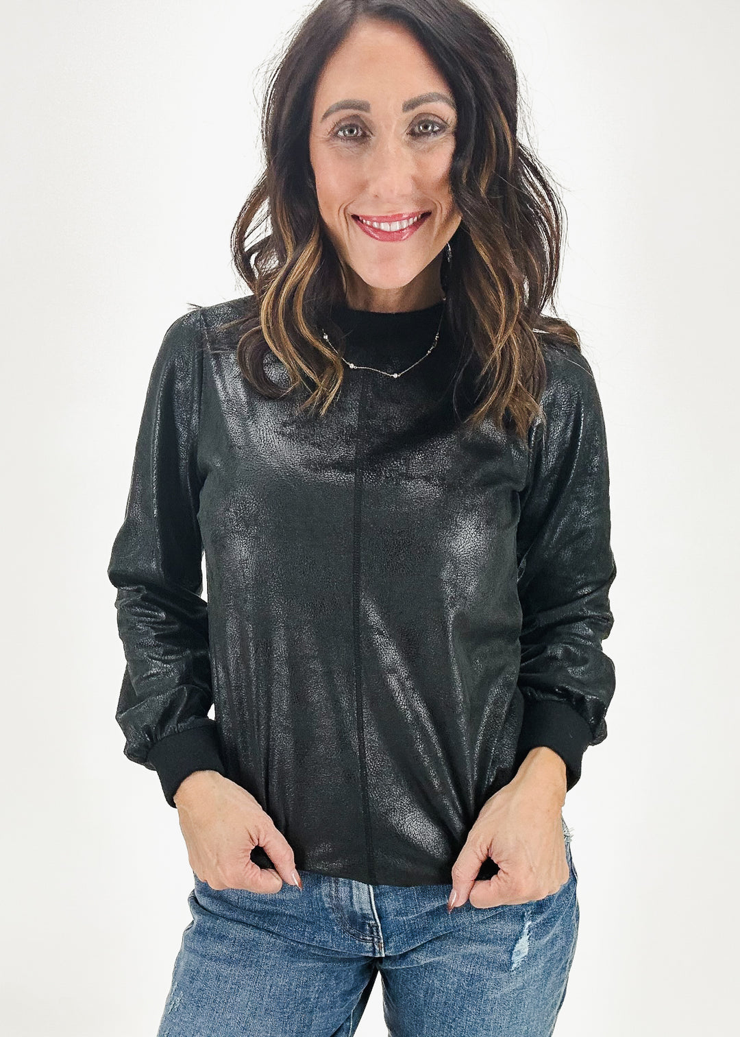 Black metallic women's crew neck top with long sleeves and a sleek, shimmering design, shown from the front.