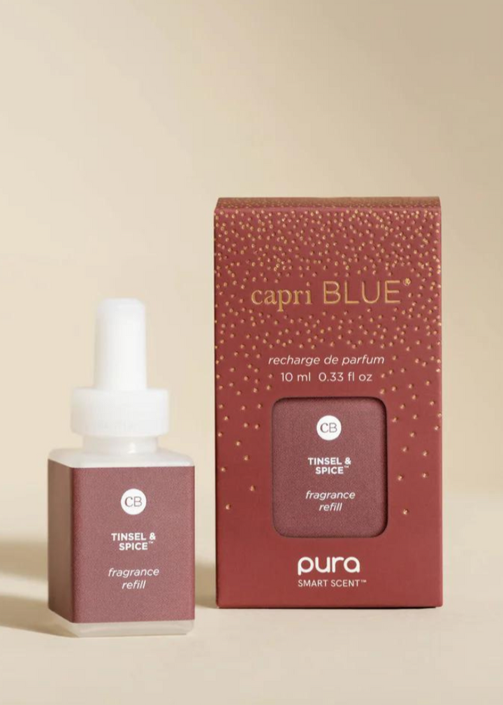 Capri Blue Pura Diffuser Refill in Tinsel & Spice scent, featuring a festive fragrance refill bottle and packaging.