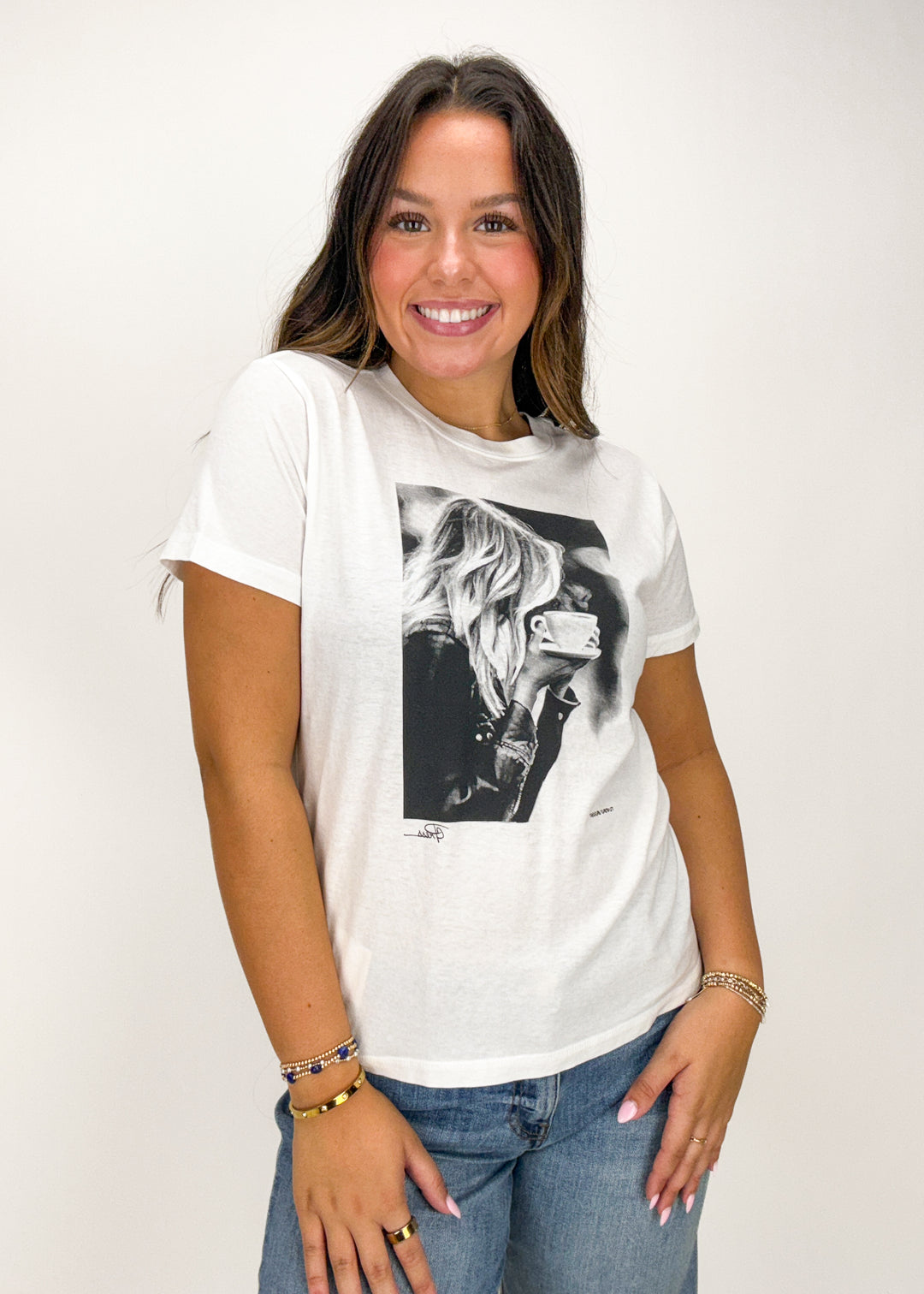 Woman wearing a white t-shirt with a graphic design