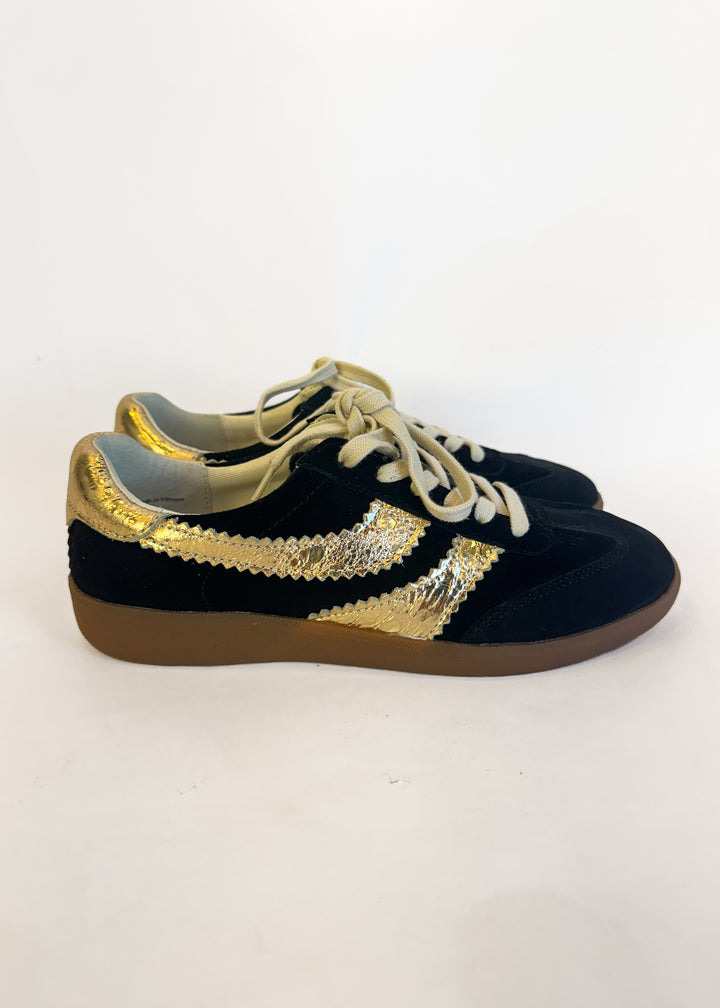 Black and gold sneakers with sequin details on a white background