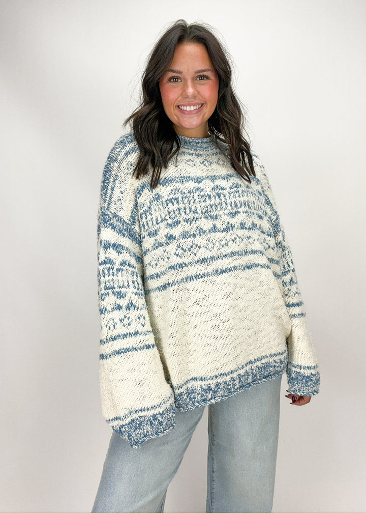 Woman wearing a blue and white patterned sweater