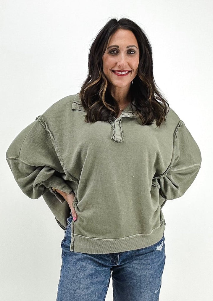 oak green oversized henley sweatshirt with raw seam details and slits on side from Free People