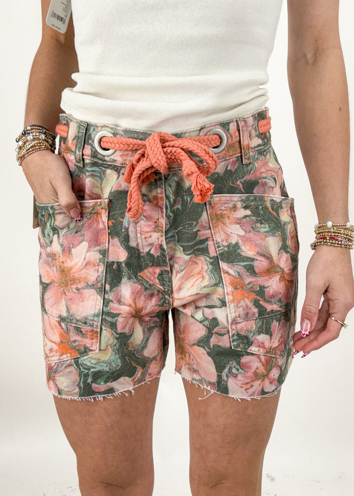 Floral shorts with a drawstring waistband worn by a person on a white background