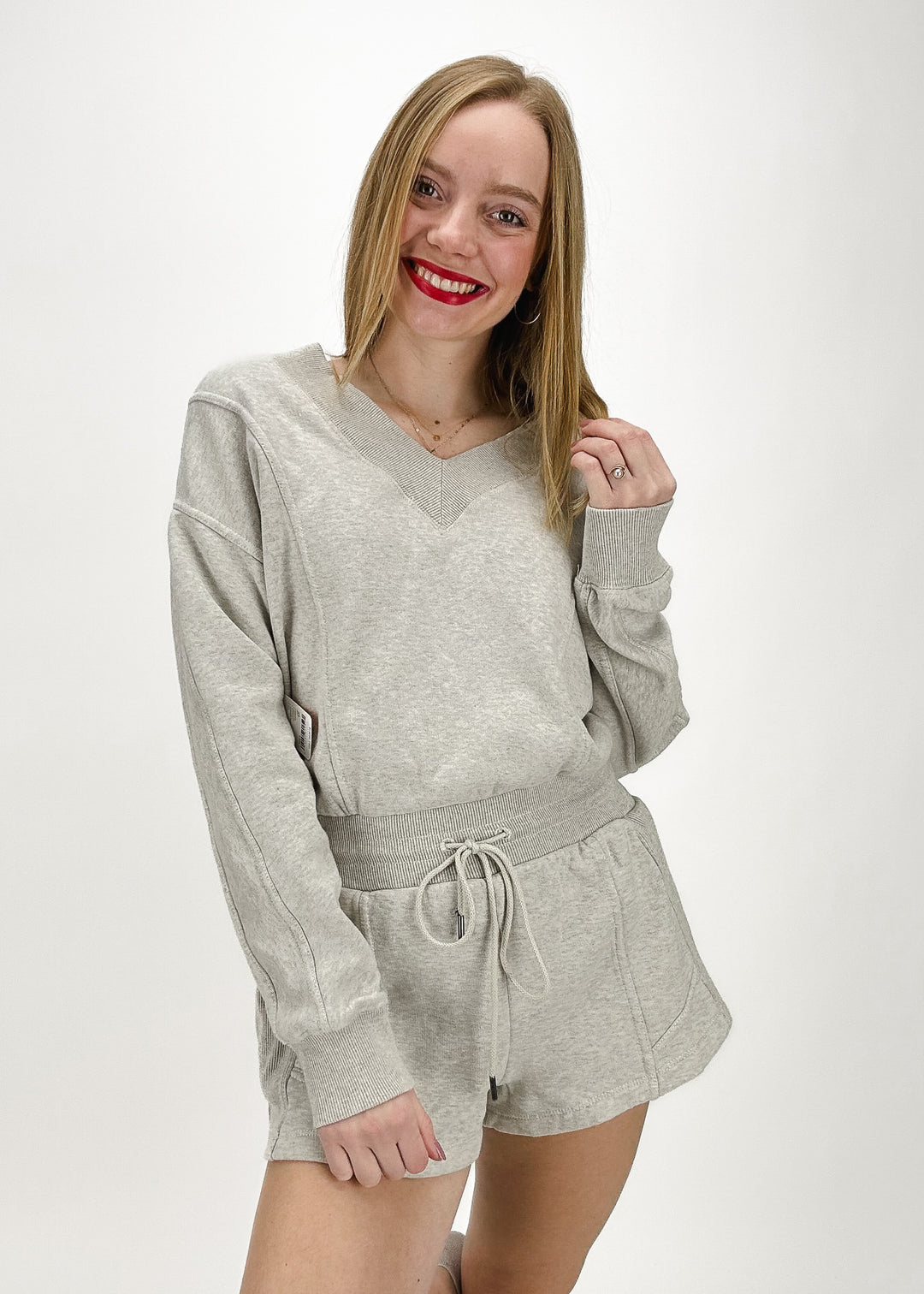 heather grey v-neck sweatshirt and drawstring micro short romper