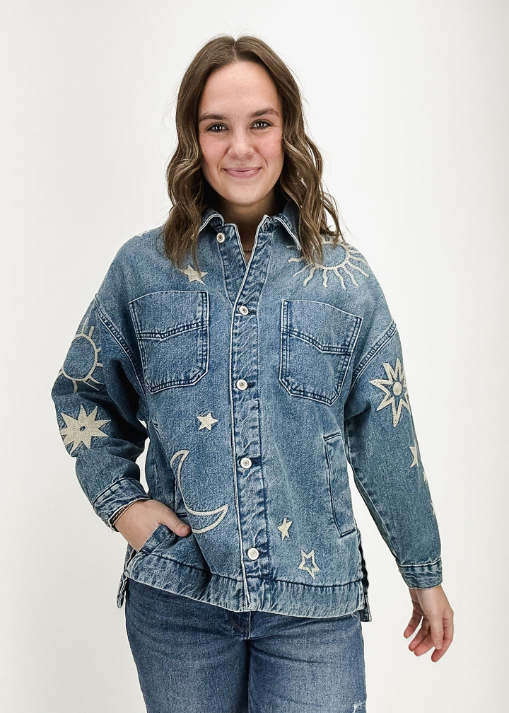 medium wash collared denim jacket with embroidered sun, moon, and stars details