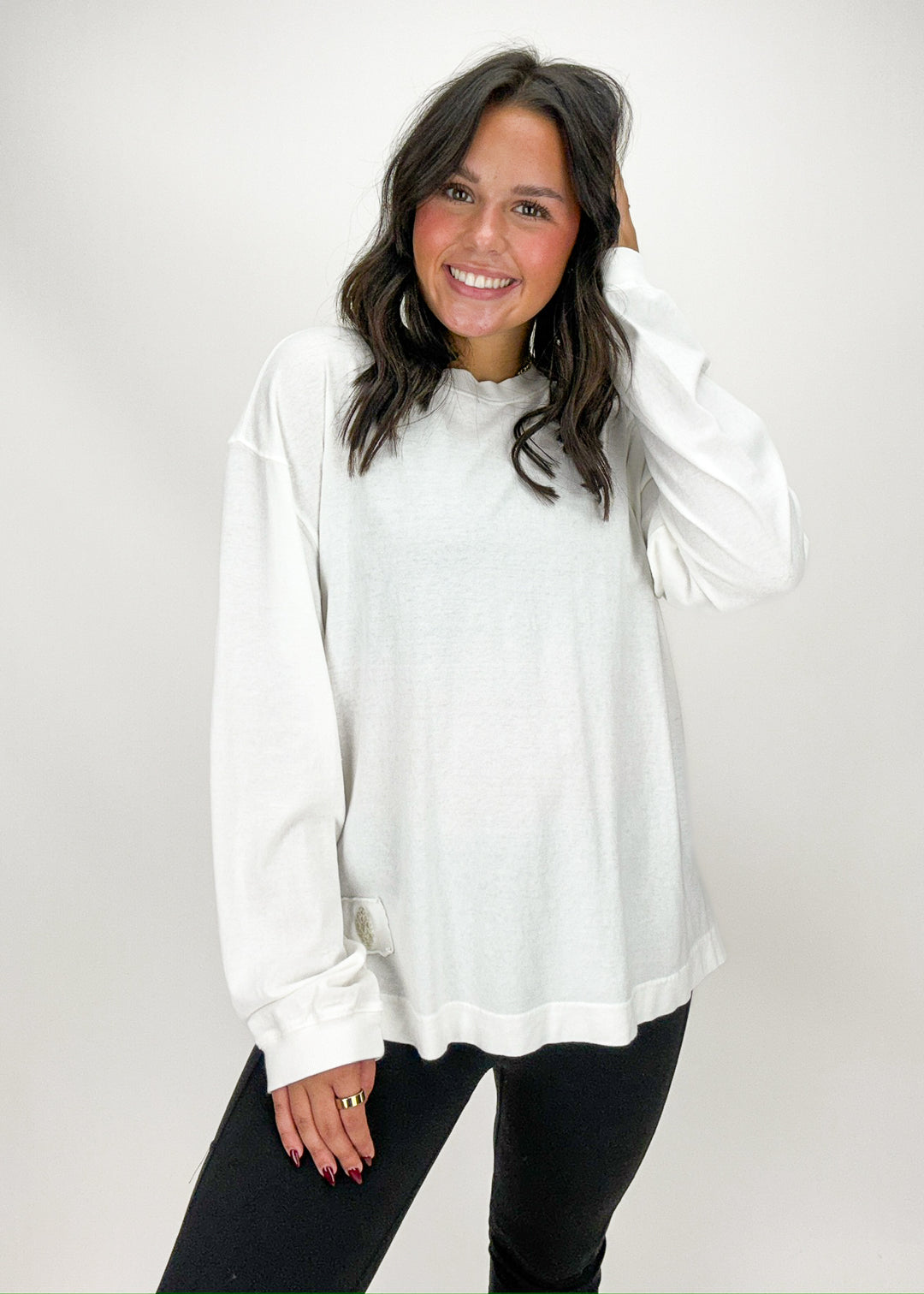 Woman wearing a white long-sleeve top 