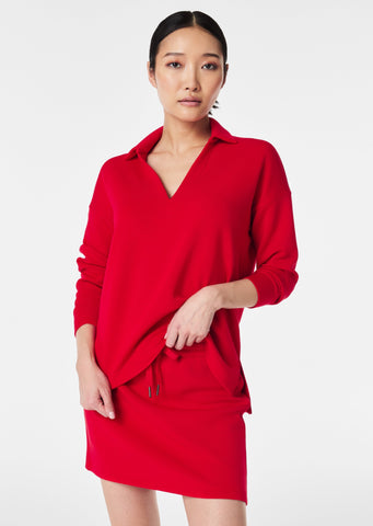 red loose fit spanx split neck collared long sleeve polo with slit details on side hems