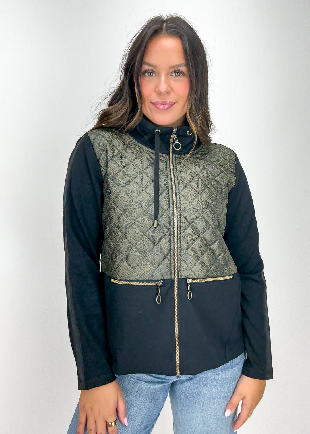 Woman wearing a black and green quilted jacket 