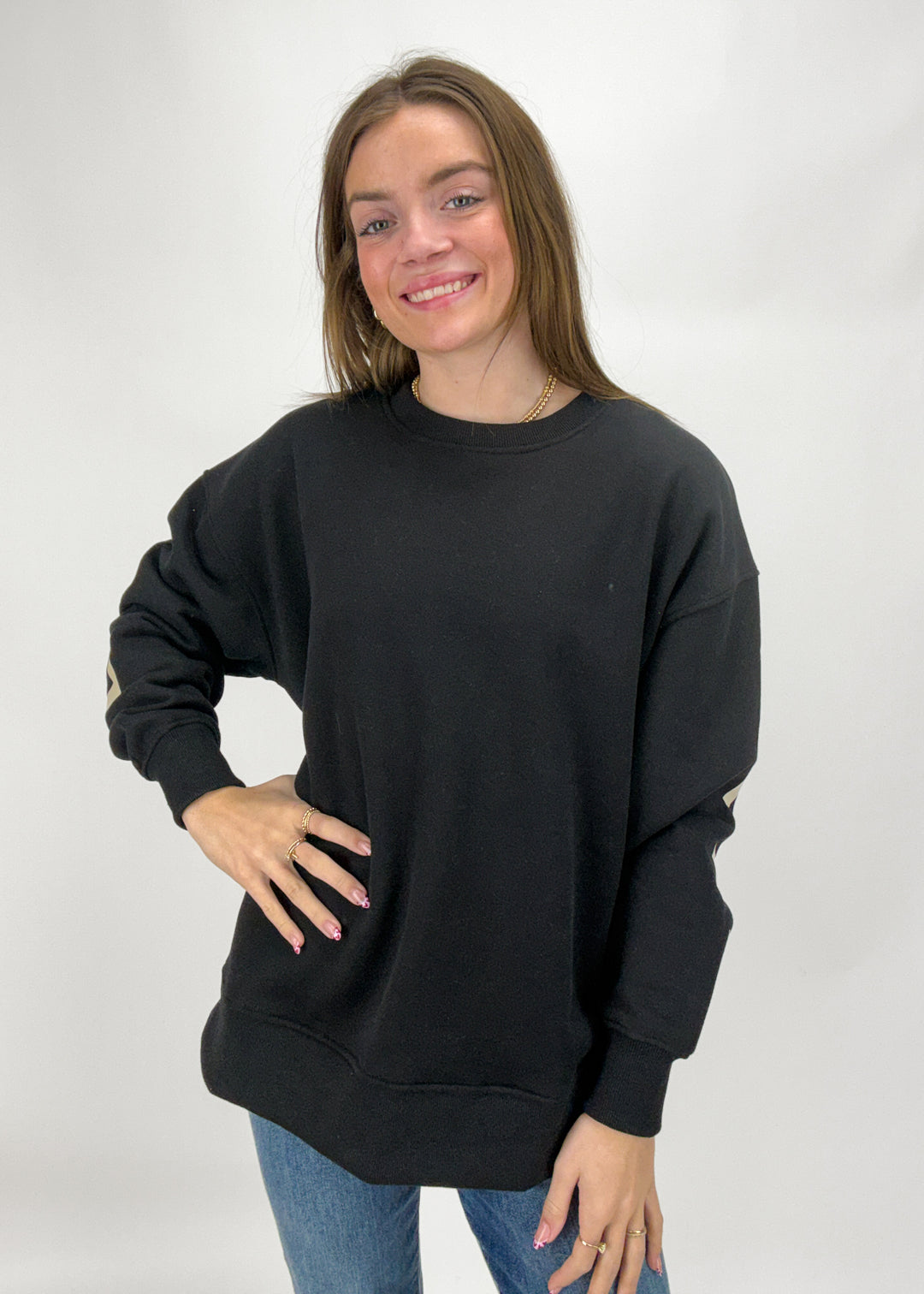 Woman wearing a black sweatshirt against a white background