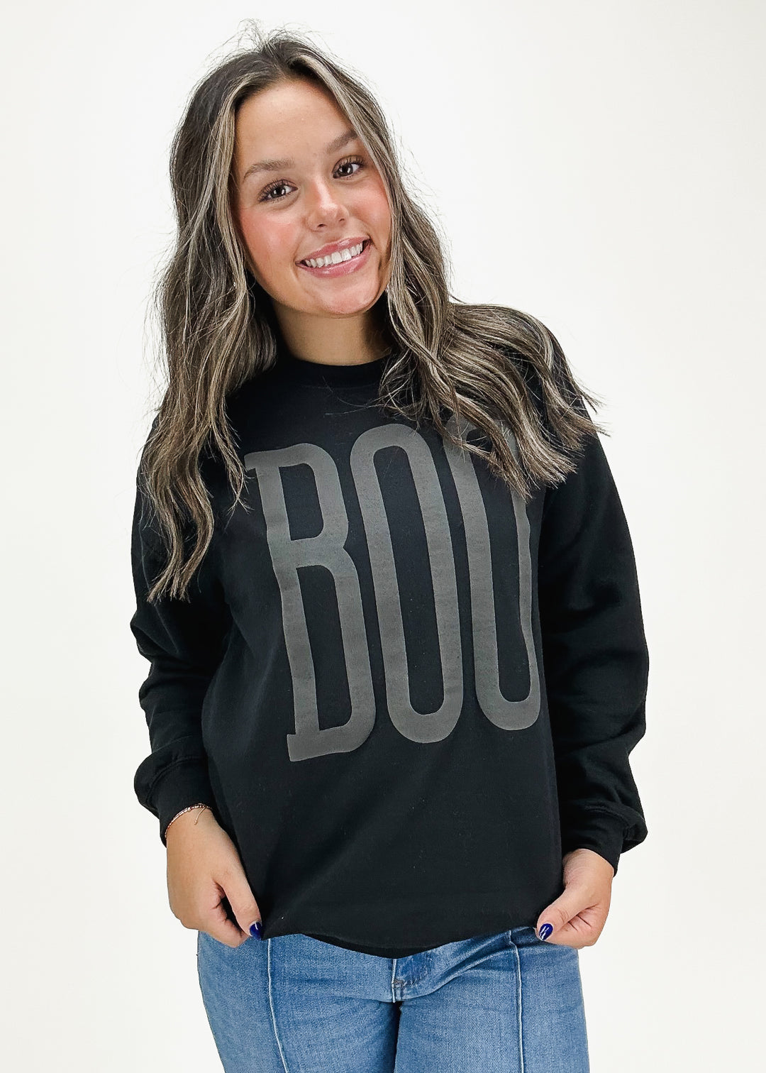 Women's black oversized "Boo" crew neck sweatshirt, perfect for a stylish and cozy Halloween look.