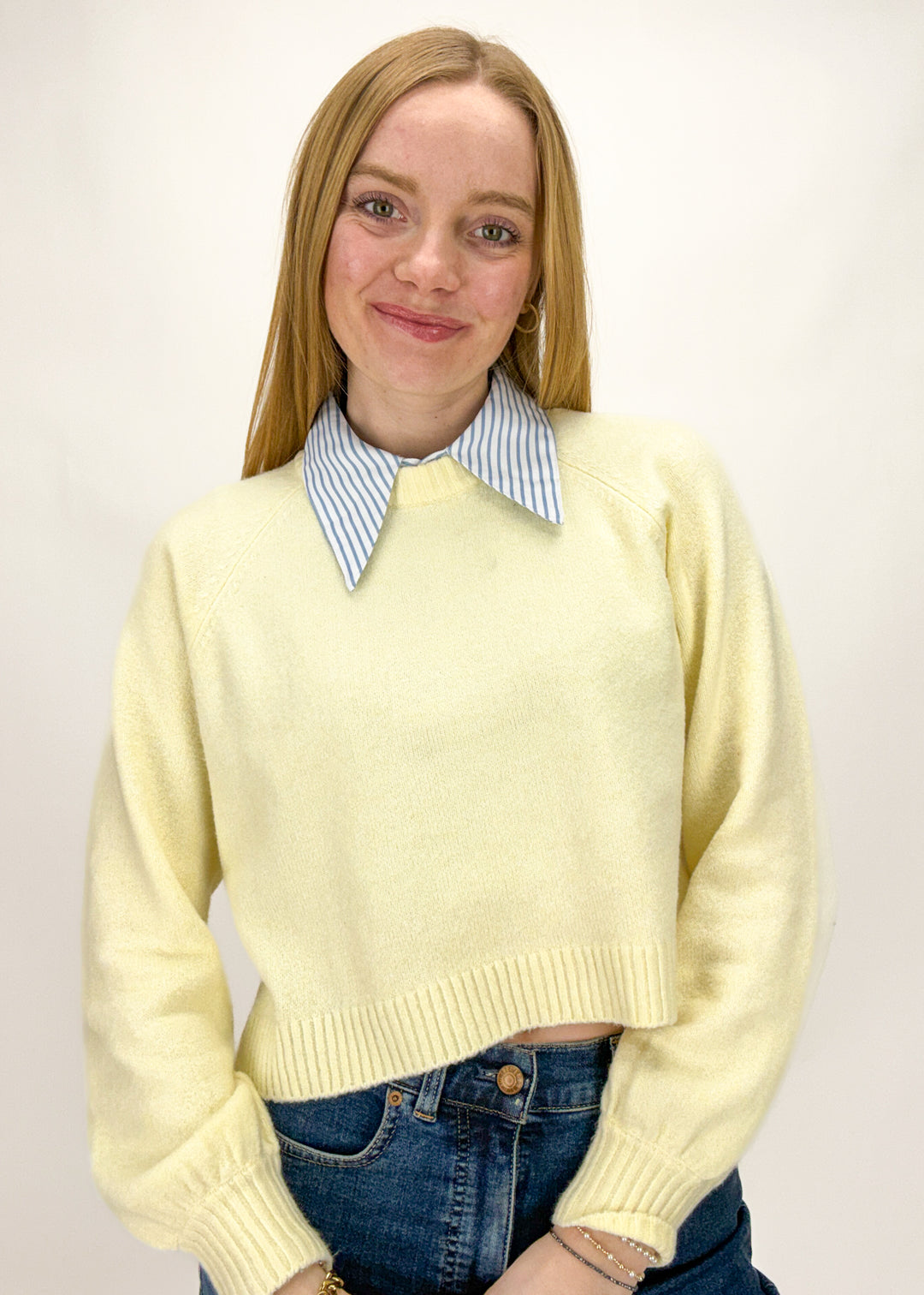 Person wearing a blue and white stripe layering dickey