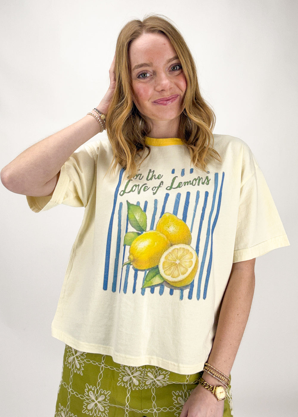 Woman wearing a lemon-themed t-shirt with text on a white background
