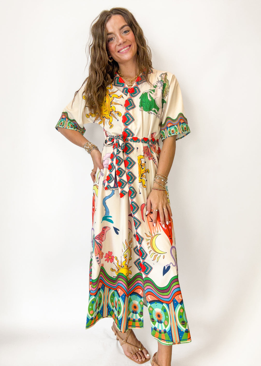 Woman wearing a colorful patterned dress against a white background