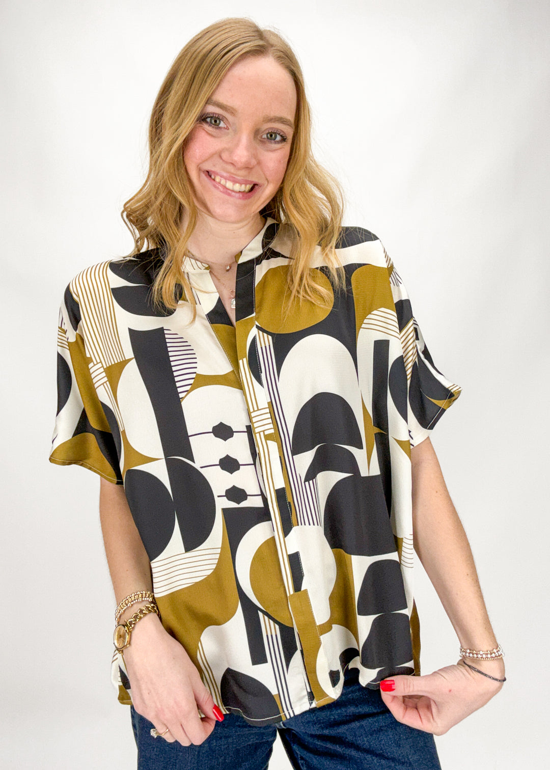 Woman wearing a patterned shirt with a white background