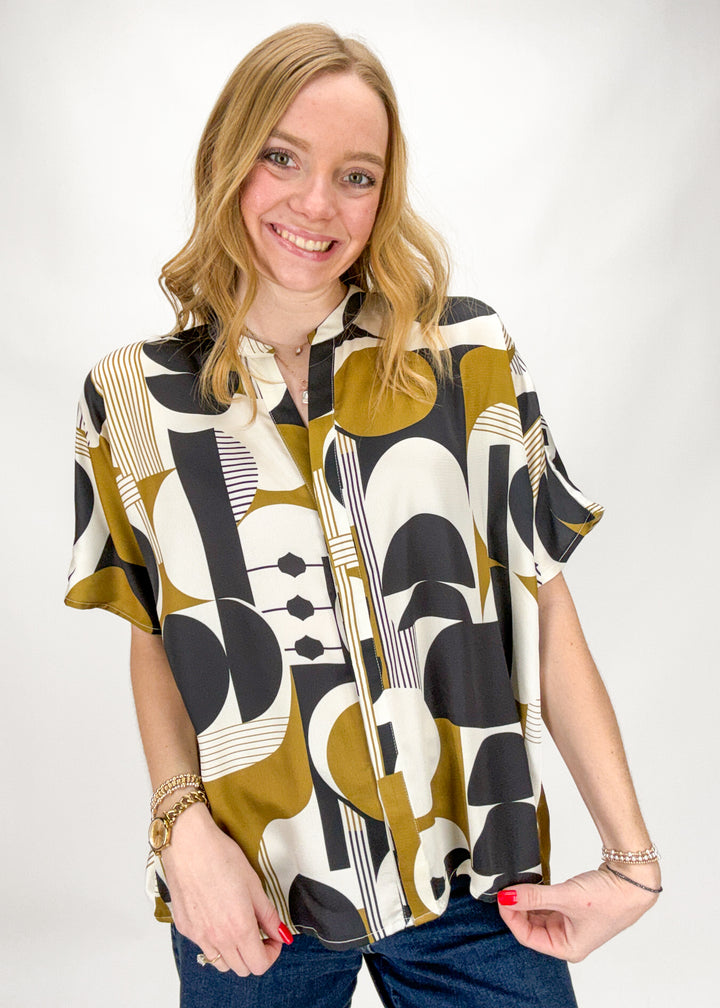Woman wearing a patterned shirt with a white background