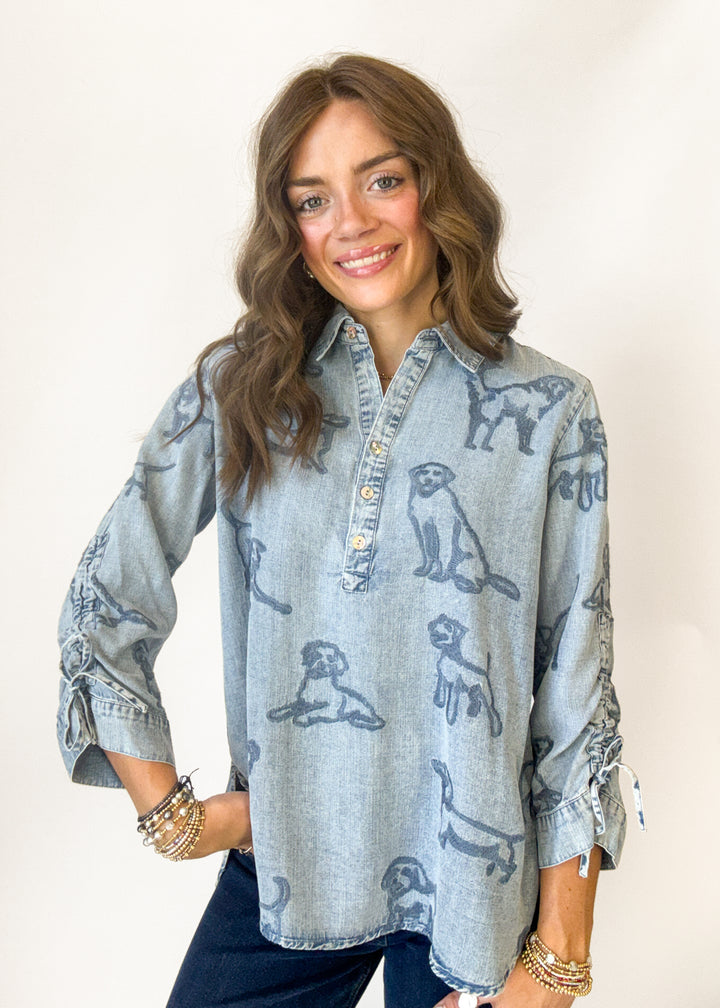 Woman wearing a denim top with puppy embroidery