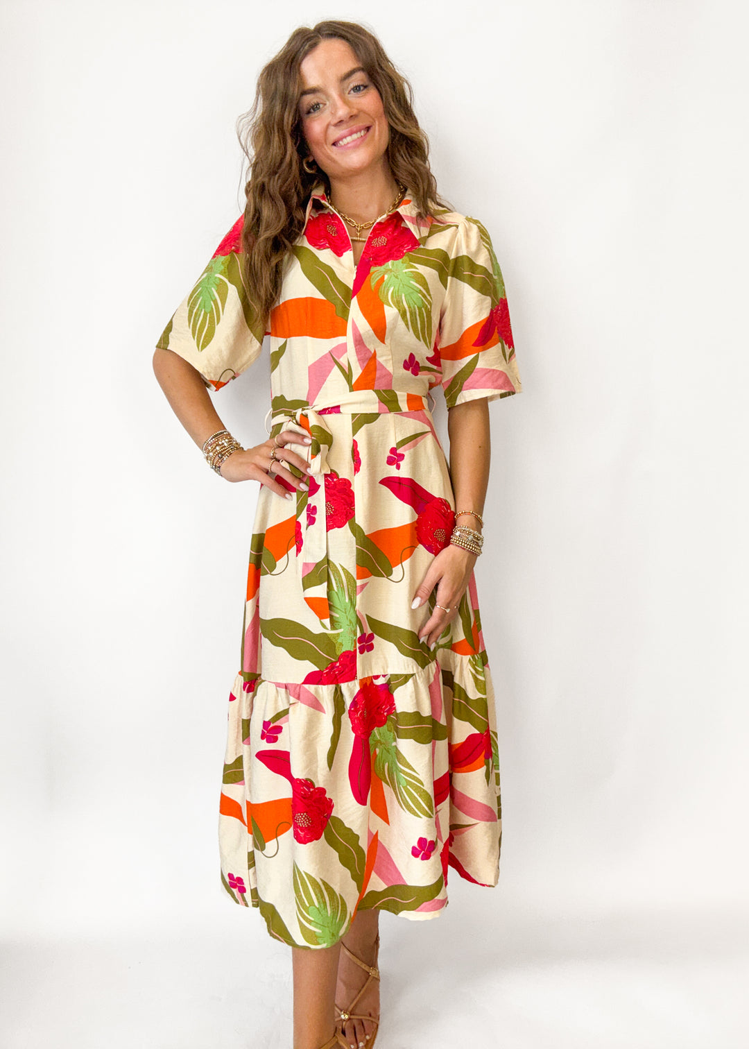 Woman wearing a colorful floral dress on a white background