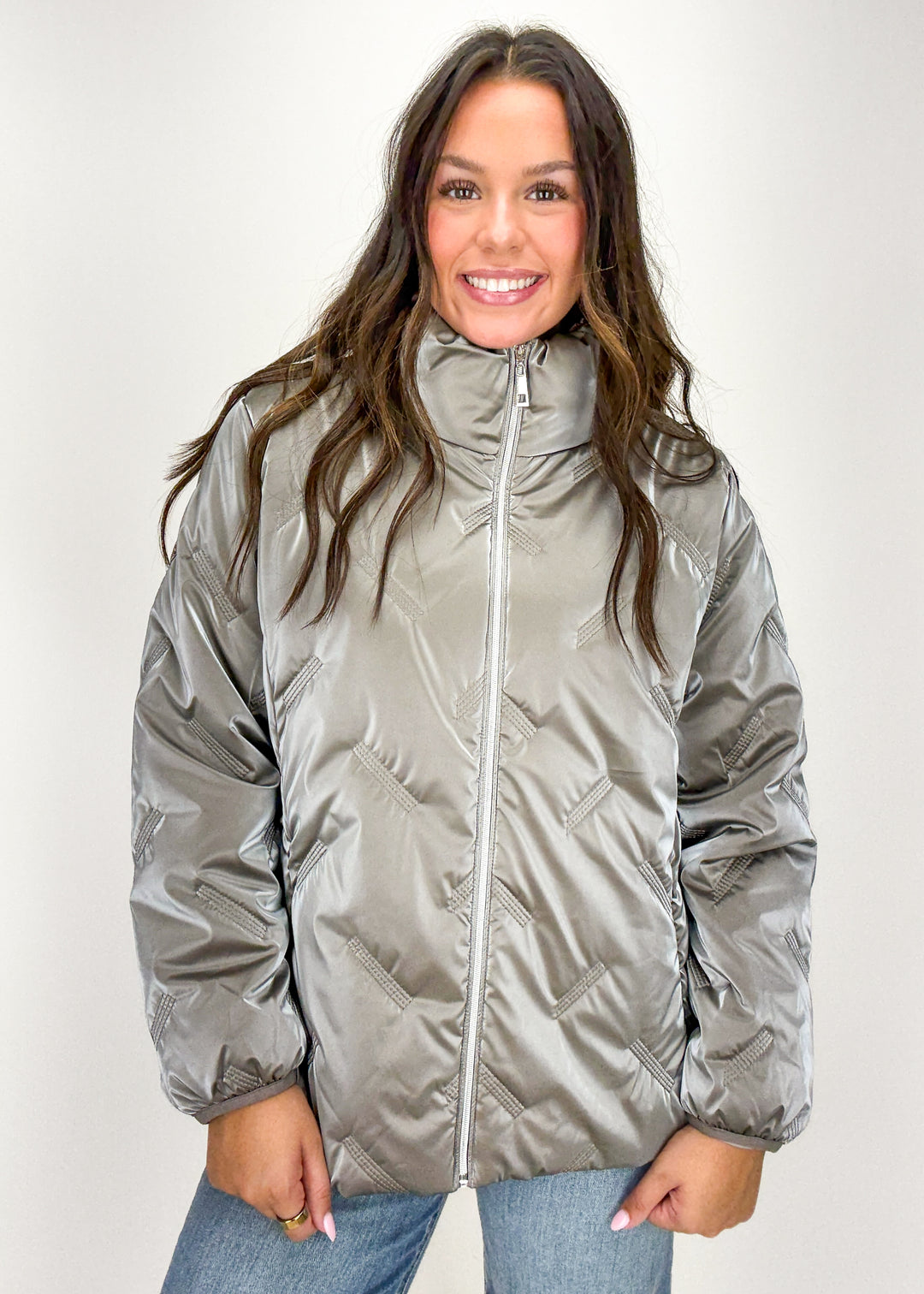 Woman wearing a silver puffer jacket 