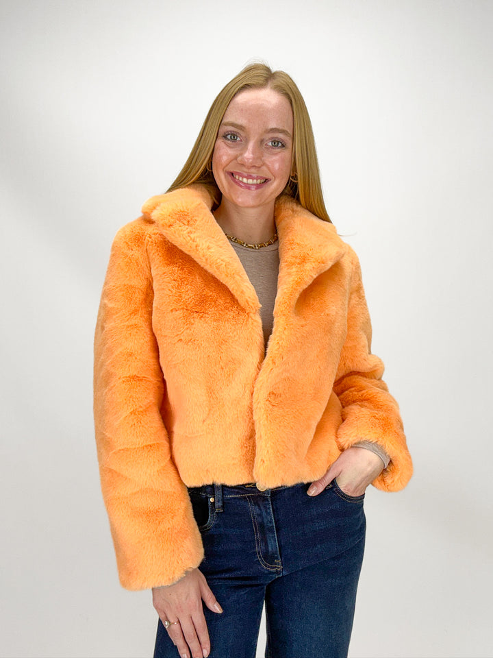 Person wearing an orange faux fur jacket 