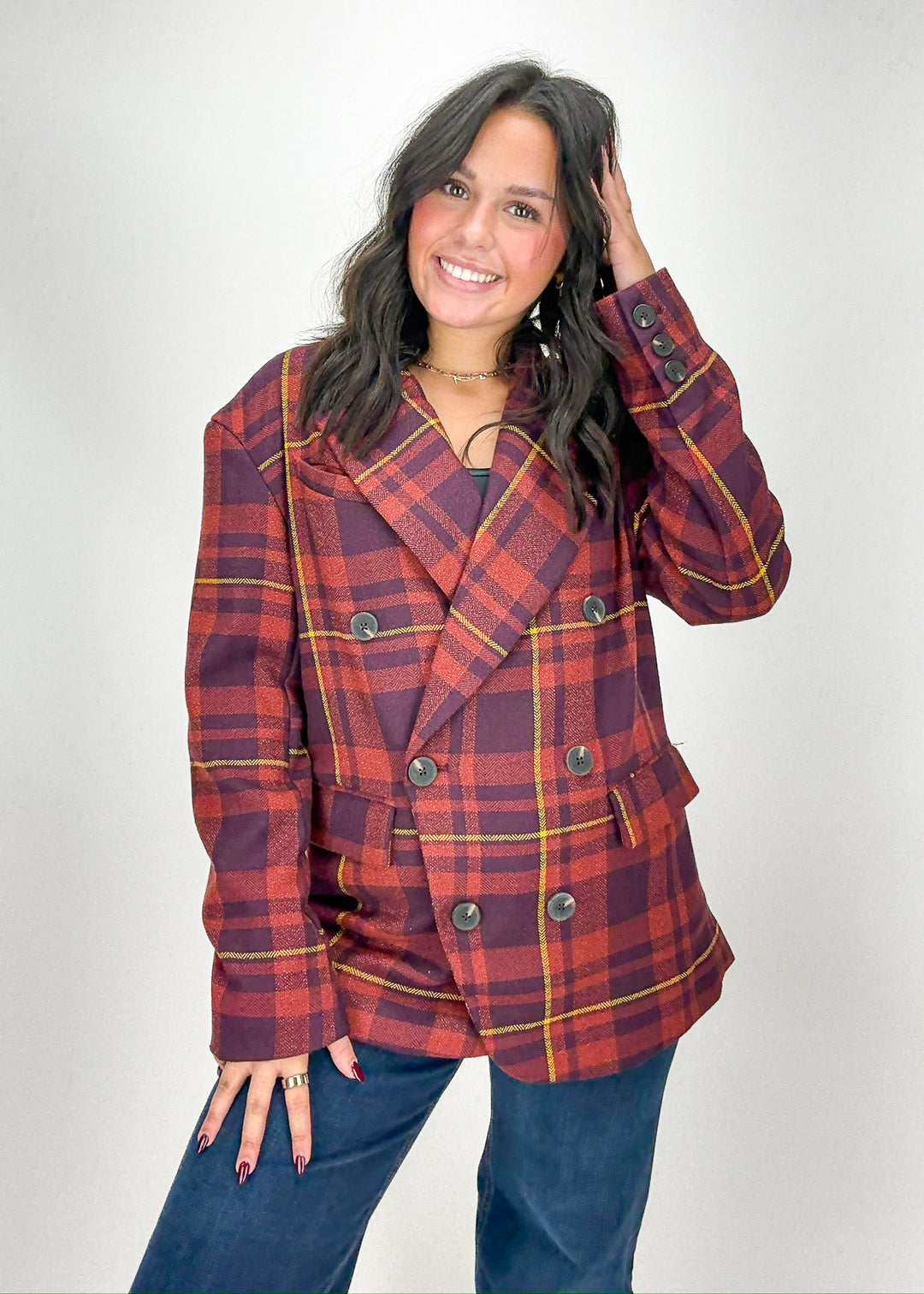 Woman wearing a red and blue plaid jacket 