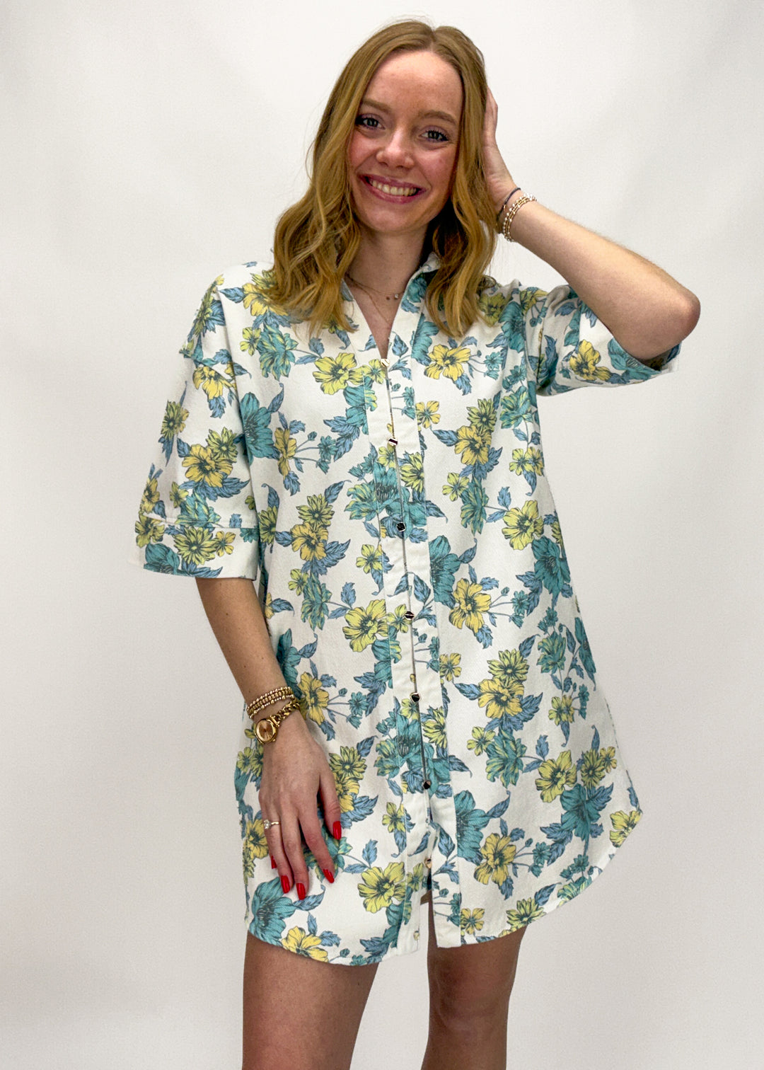 Woman wearing a floral dress with a plain background