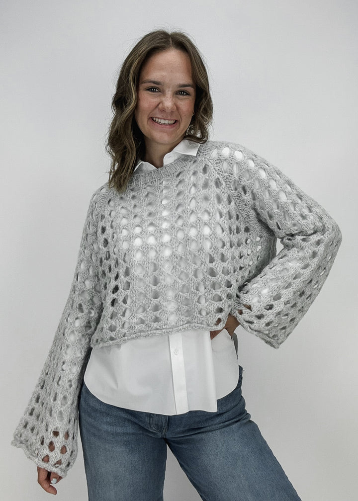 white collared top with grey knit sweater layered over 