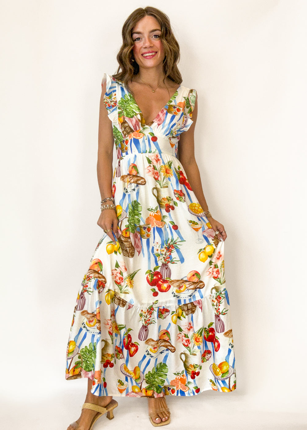 woman wearing a cream maxi dress with pinic print