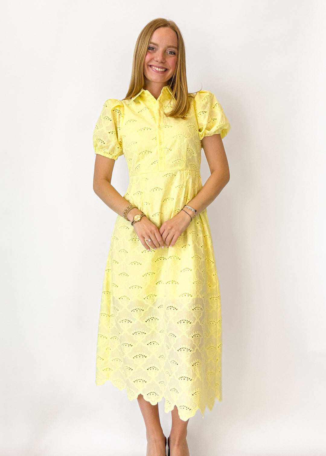 Woman wearing a yellow dress against a white background